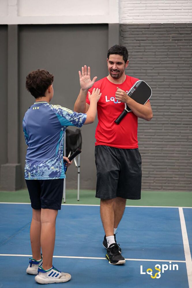 Lucas dando um high-five a um aluno durante aula